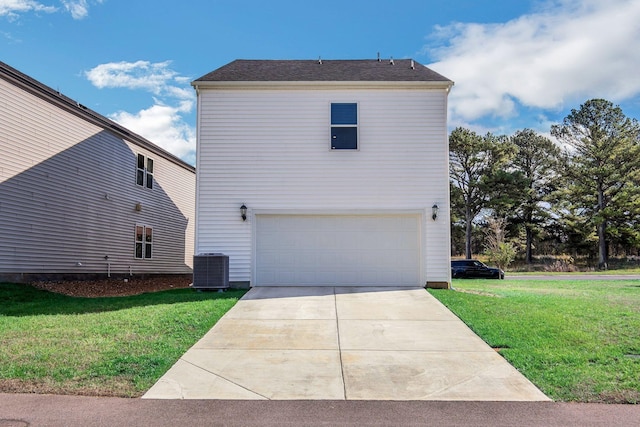 exterior space with an attached garage, a front lawn, and central AC unit