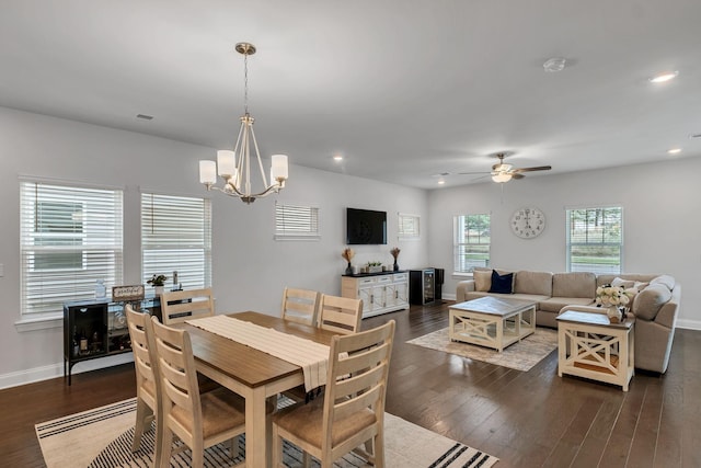 dining room featuring ceiling fan with notable chandelier, baseboards, dark wood-type flooring, and recessed lighting