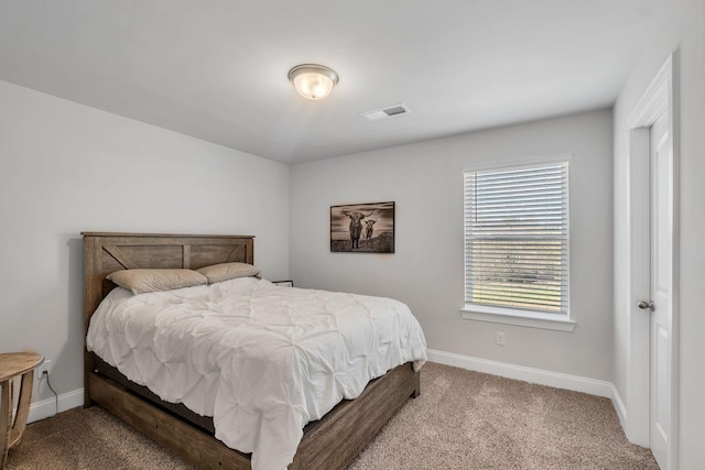 carpeted bedroom with visible vents and baseboards