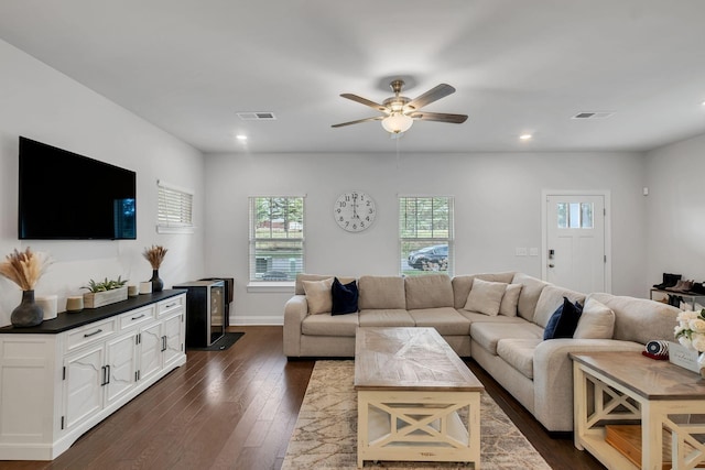 living room with ceiling fan, visible vents, dark wood finished floors, and recessed lighting