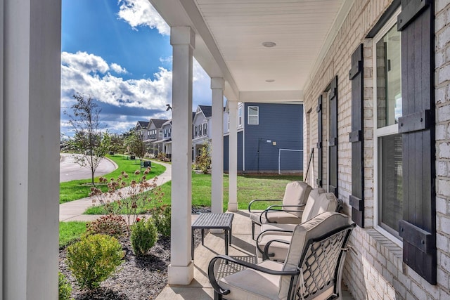 view of patio / terrace with a residential view and covered porch