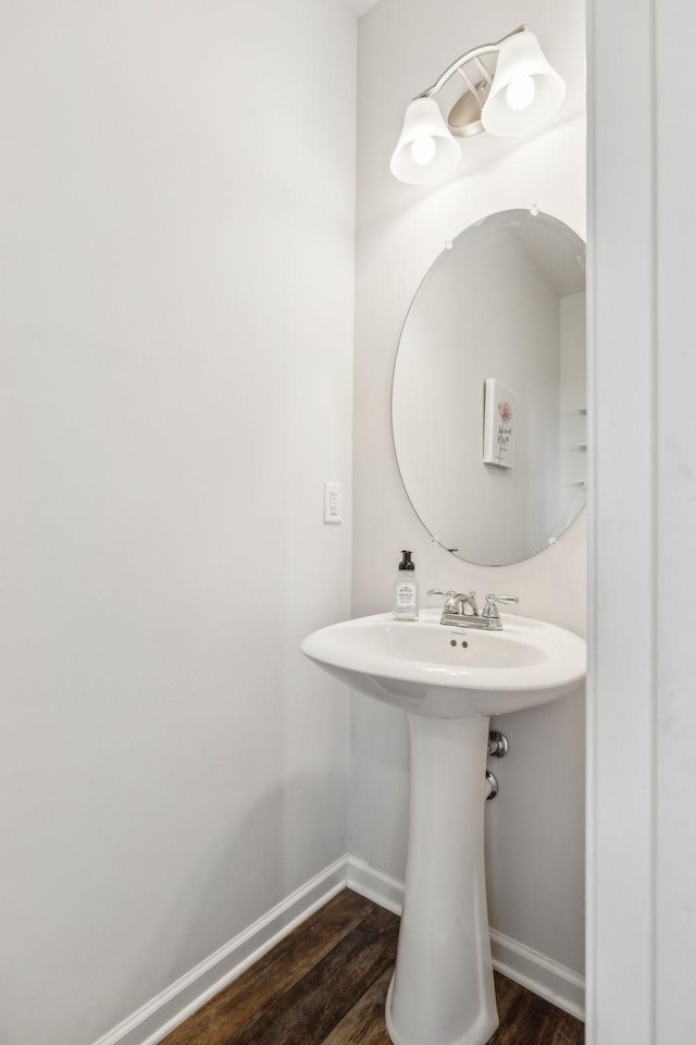 bathroom with baseboards and wood finished floors