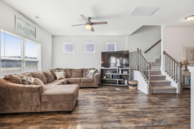 living area featuring stairway, a ceiling fan, visible vents, and wood finished floors