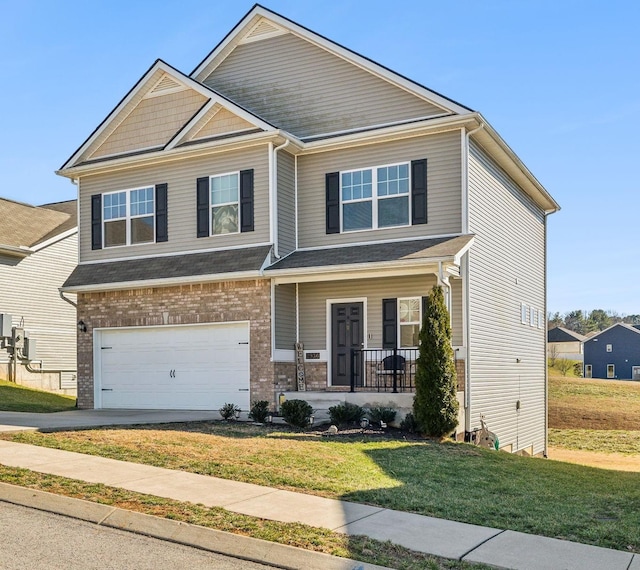 craftsman house featuring brick siding, a porch, a front yard, a garage, and driveway