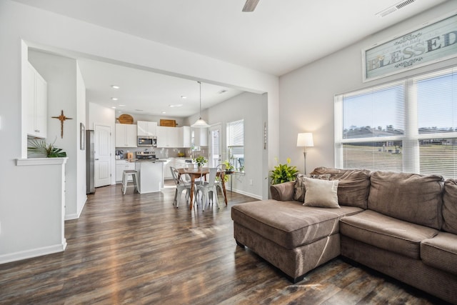 living area with recessed lighting, visible vents, dark wood-type flooring, a ceiling fan, and baseboards