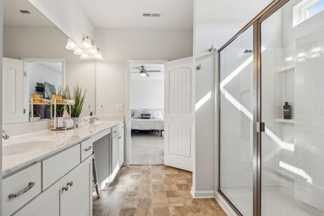 full bathroom featuring double vanity, visible vents, ensuite bathroom, a stall shower, and a sink