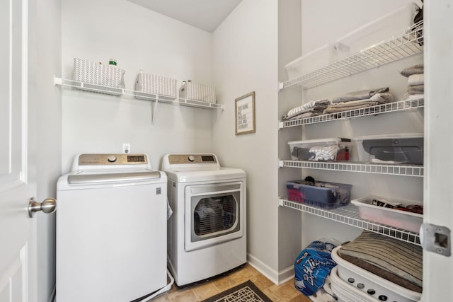 clothes washing area with laundry area, baseboards, and independent washer and dryer