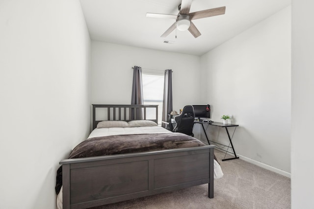 bedroom featuring carpet floors, baseboards, visible vents, and a ceiling fan