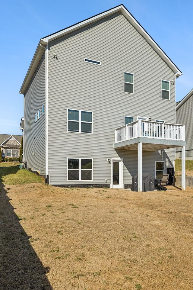 back of property featuring a lawn and a wooden deck