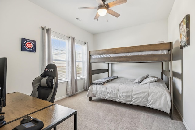 carpeted bedroom with ceiling fan, visible vents, and baseboards