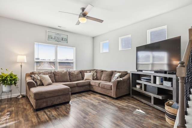 living room featuring dark wood-style floors, visible vents, ceiling fan, and baseboards