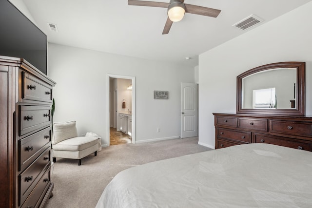 bedroom with light carpet, baseboards, visible vents, and connected bathroom