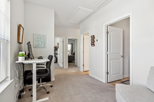 home office with visible vents, baseboards, attic access, and light colored carpet