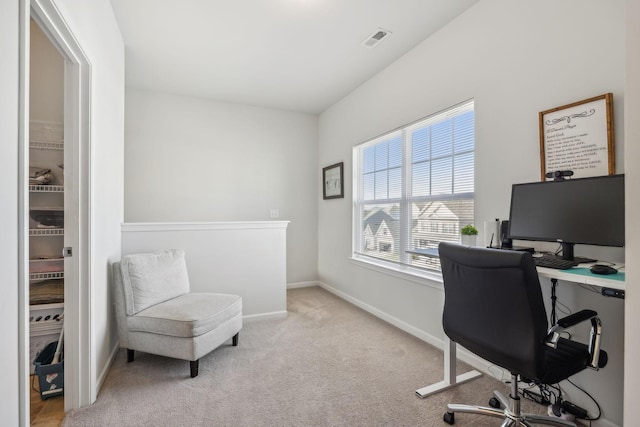 office space with light carpet, baseboards, and visible vents