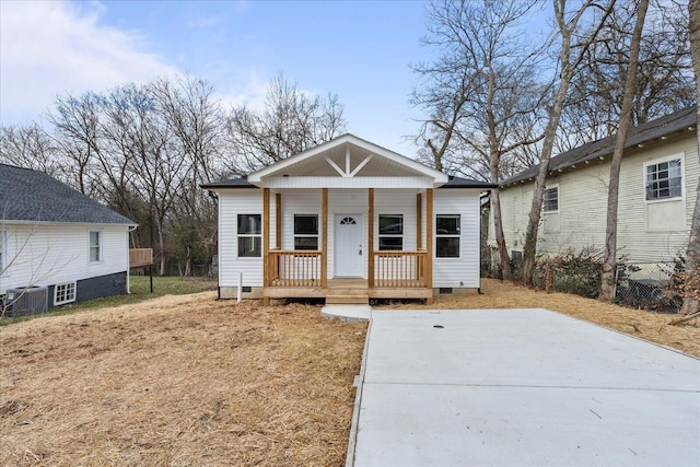 bungalow featuring cooling unit, covered porch, and crawl space