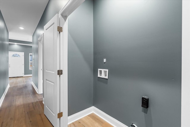 corridor featuring baseboards and wood finished floors