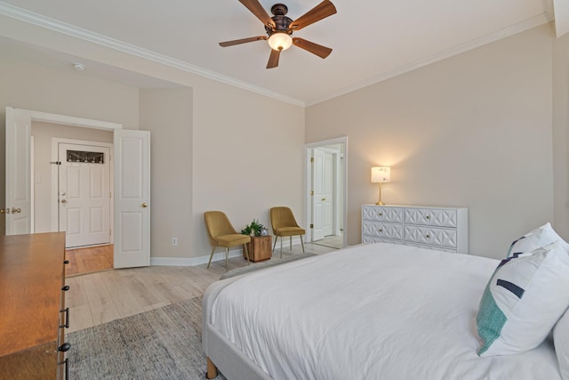 bedroom featuring a ceiling fan, baseboards, crown molding, and wood finished floors