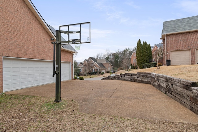 exterior space featuring a garage and a residential view