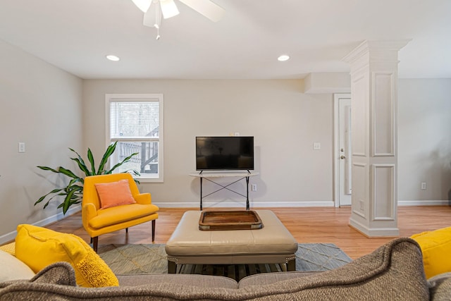 living area with recessed lighting, decorative columns, light wood-style flooring, and baseboards