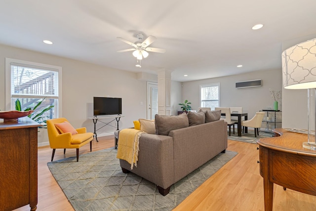 living room with light wood finished floors, decorative columns, ceiling fan, and recessed lighting