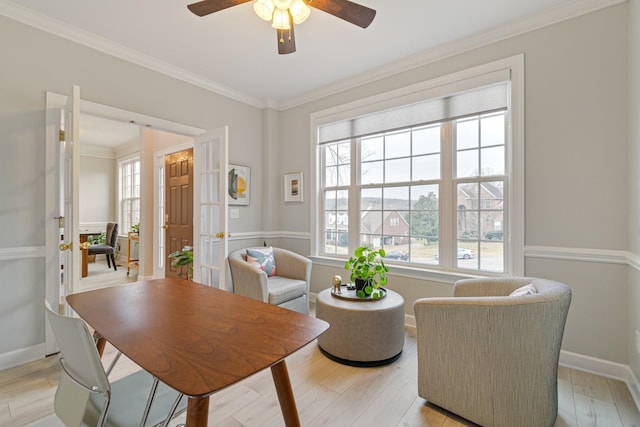 interior space with baseboards, ornamental molding, and light wood-style floors