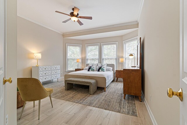 bedroom featuring baseboards, ceiling fan, light wood-style flooring, and crown molding