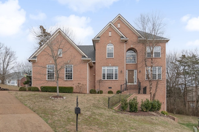 view of front of home featuring crawl space and brick siding