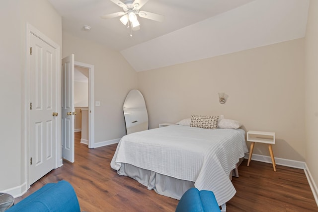 bedroom featuring a ceiling fan, lofted ceiling, baseboards, and wood finished floors