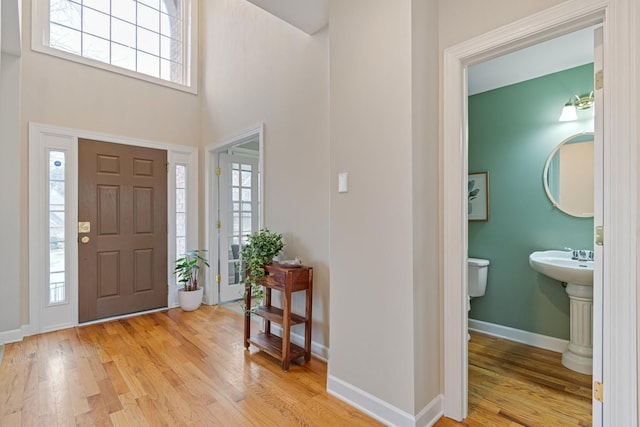 entryway with light wood-type flooring and baseboards