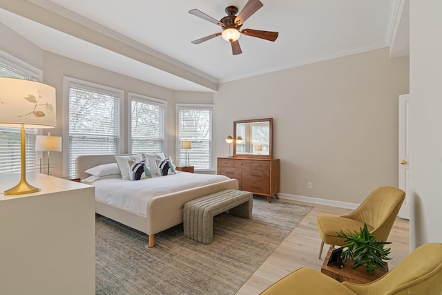 bedroom featuring light wood-type flooring, baseboards, ornamental molding, and a ceiling fan