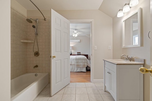 ensuite bathroom featuring ensuite bath, a wall mounted air conditioner, tile patterned floors, bathtub / shower combination, and vanity