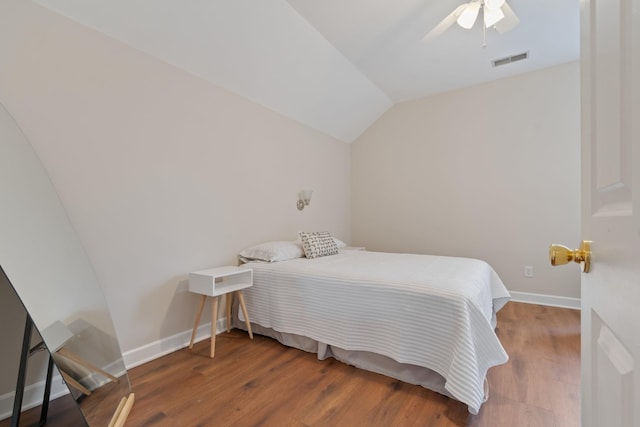 bedroom featuring lofted ceiling, ceiling fan, wood finished floors, visible vents, and baseboards