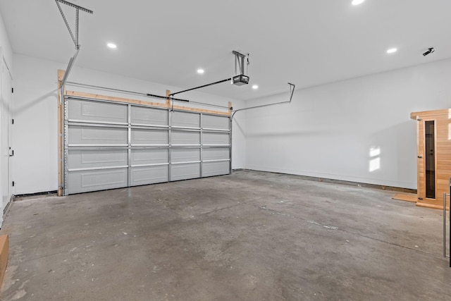 garage with recessed lighting, baseboards, and a garage door opener