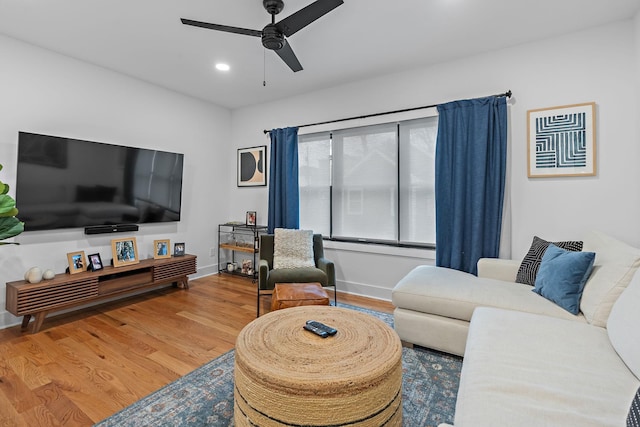 living area with ceiling fan, baseboards, wood finished floors, and recessed lighting