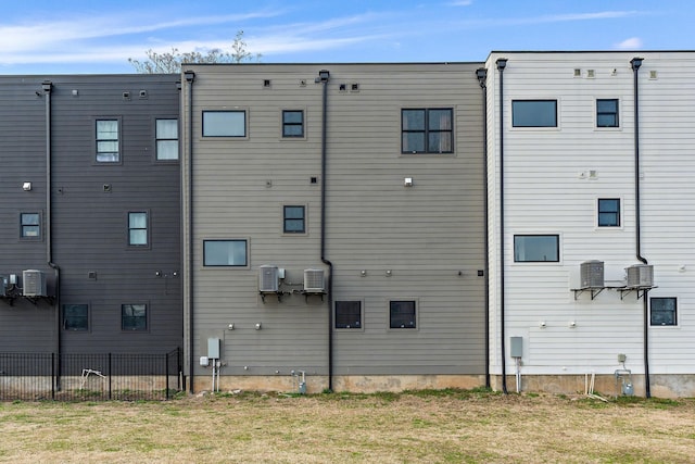 rear view of property featuring fence