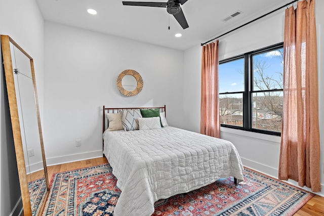 bedroom with recessed lighting, wood finished floors, a ceiling fan, visible vents, and baseboards