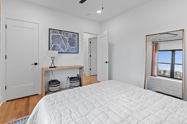 bedroom with a ceiling fan, recessed lighting, and wood finished floors