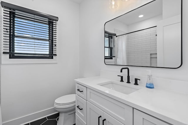 bathroom with baseboards, toilet, a shower with curtain, tile patterned floors, and vanity