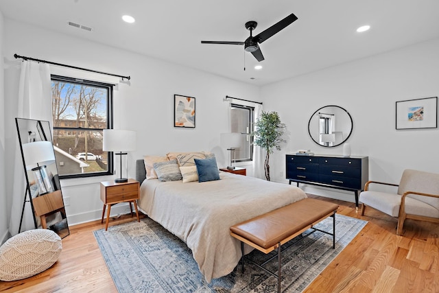 bedroom with light wood-style flooring, visible vents, baseboards, and recessed lighting