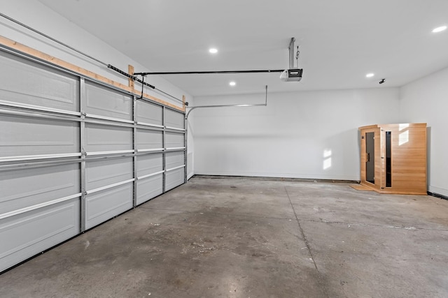 garage with recessed lighting and a garage door opener