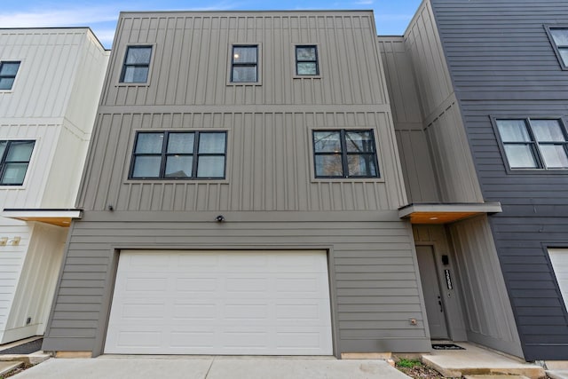 townhome / multi-family property featuring board and batten siding and a garage