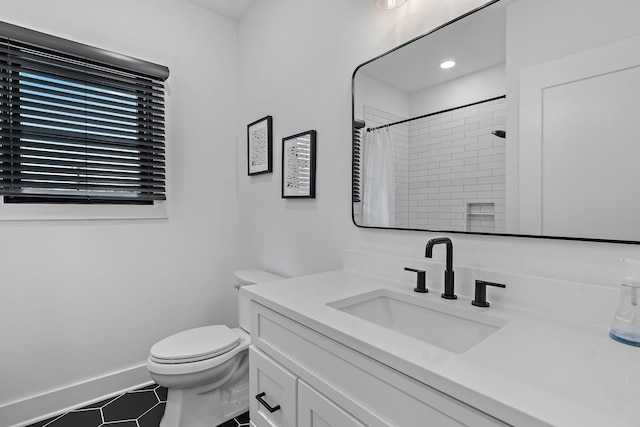 bathroom featuring baseboards, toilet, curtained shower, tile patterned flooring, and vanity