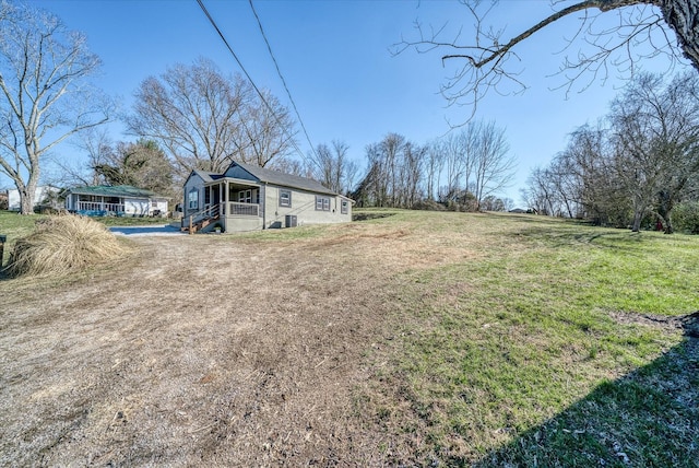 view of yard featuring covered porch and driveway