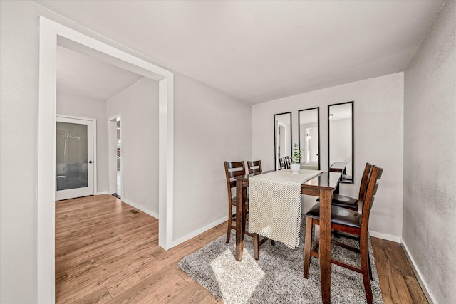 dining area featuring wood finished floors and baseboards