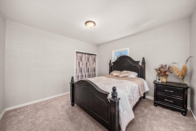 bedroom featuring light carpet and baseboards