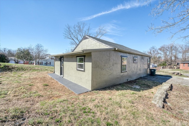 view of side of property featuring stucco siding