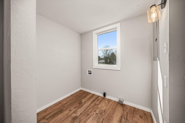 washroom featuring hookup for a washing machine, laundry area, baseboards, and wood finished floors