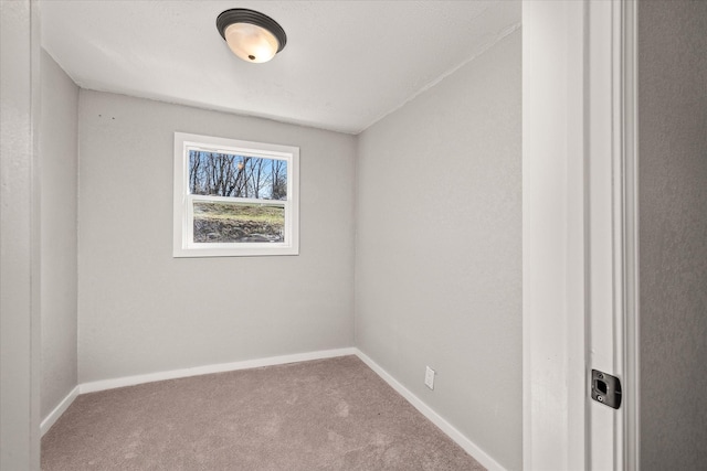 empty room with carpet and baseboards