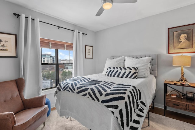 bedroom featuring baseboards, a ceiling fan, and wood finished floors