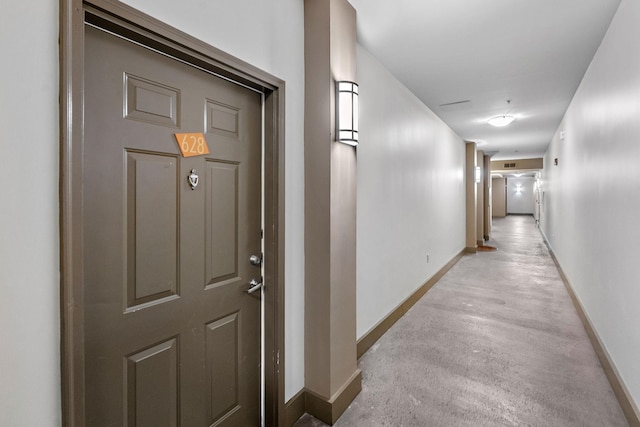 hall featuring baseboards